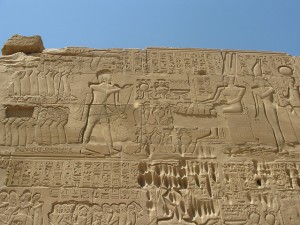 Wall of the famous Temple of Karnak. Note the story told in images.temples. Columns, walls, monuments were all covered with the ancient form of advertising. This advertising centered on the state (which centered on the monarchy). This is true even of religion as in most ancient cultures the king is also a priest of some sort or related to the gods. These images inform our reading of the texts. In fact they often shed incredible light on the text because they provide a way of entering the world the ancients lived in. Just like advertising in most magazines tell us a great deal about our own culture. This kind of study is called iconography.